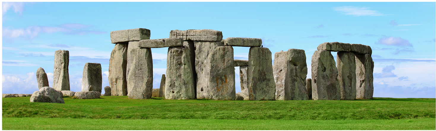 Stonehenge with luscious green grass and a calming blue sky