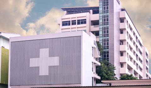 Concrete hospital building with medical cross