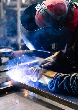 Person wearing safety gear while welding