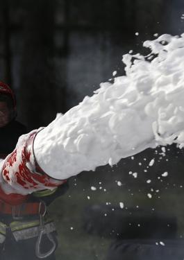 Firefighter using firefighting foam