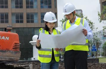 Two Bureau Veritas employees looking at building plans together