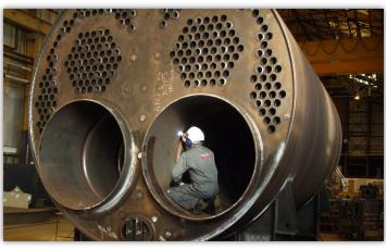Bureau Veritas employee inspects boiler