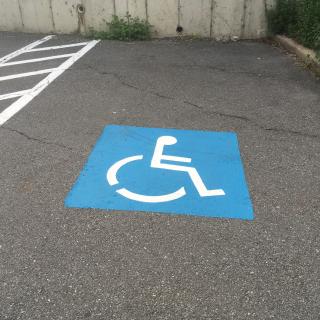 Handicap Space with blue painted marker on the ground