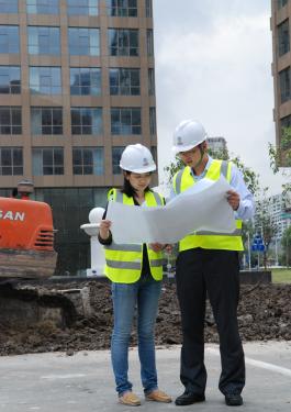 Two Bureau Veritas employees looking at building plans together